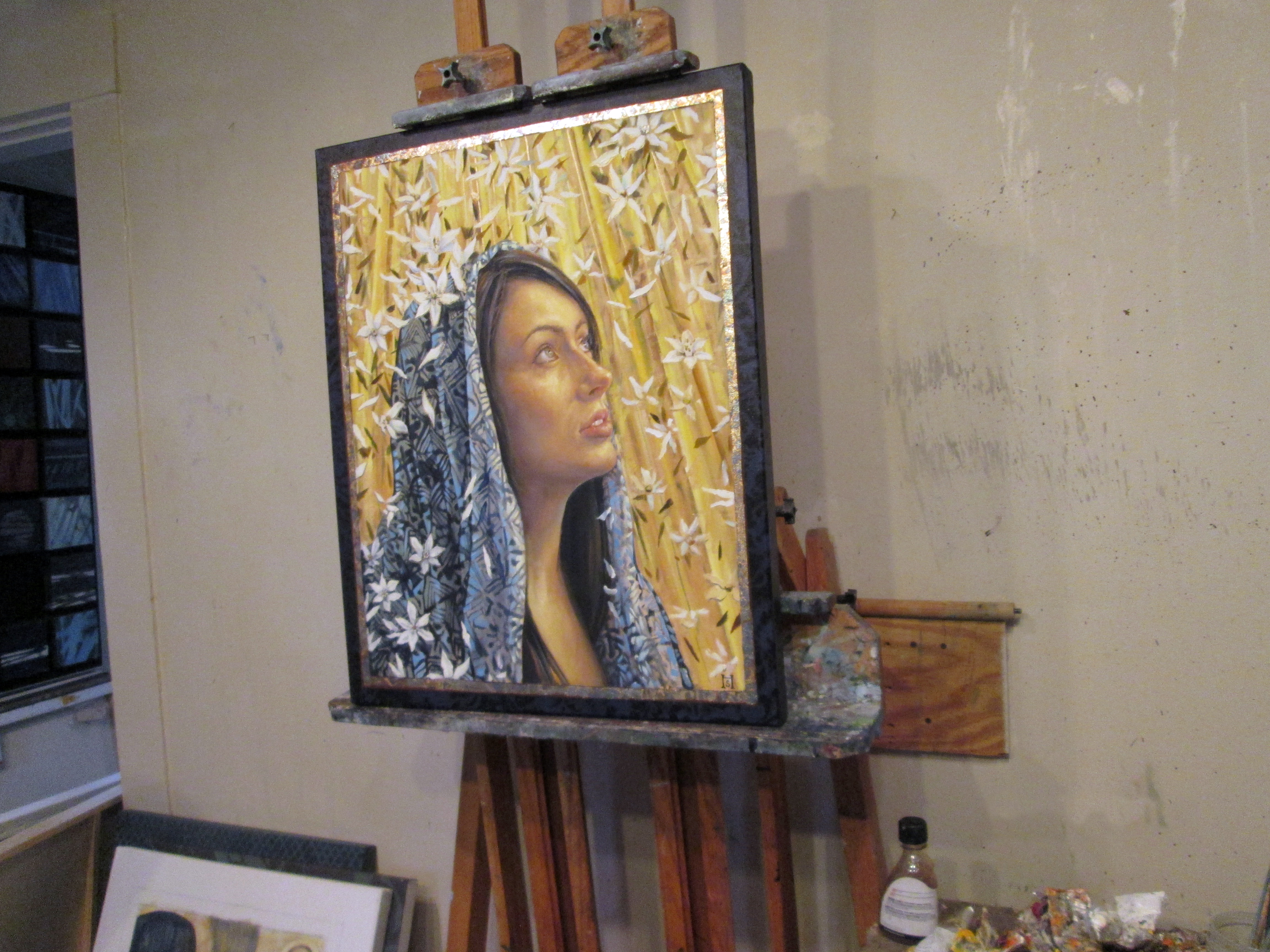 A finished painting titled "White Blossoms Covered Mary ? Star of Bethlehem" sits in the artist's studio