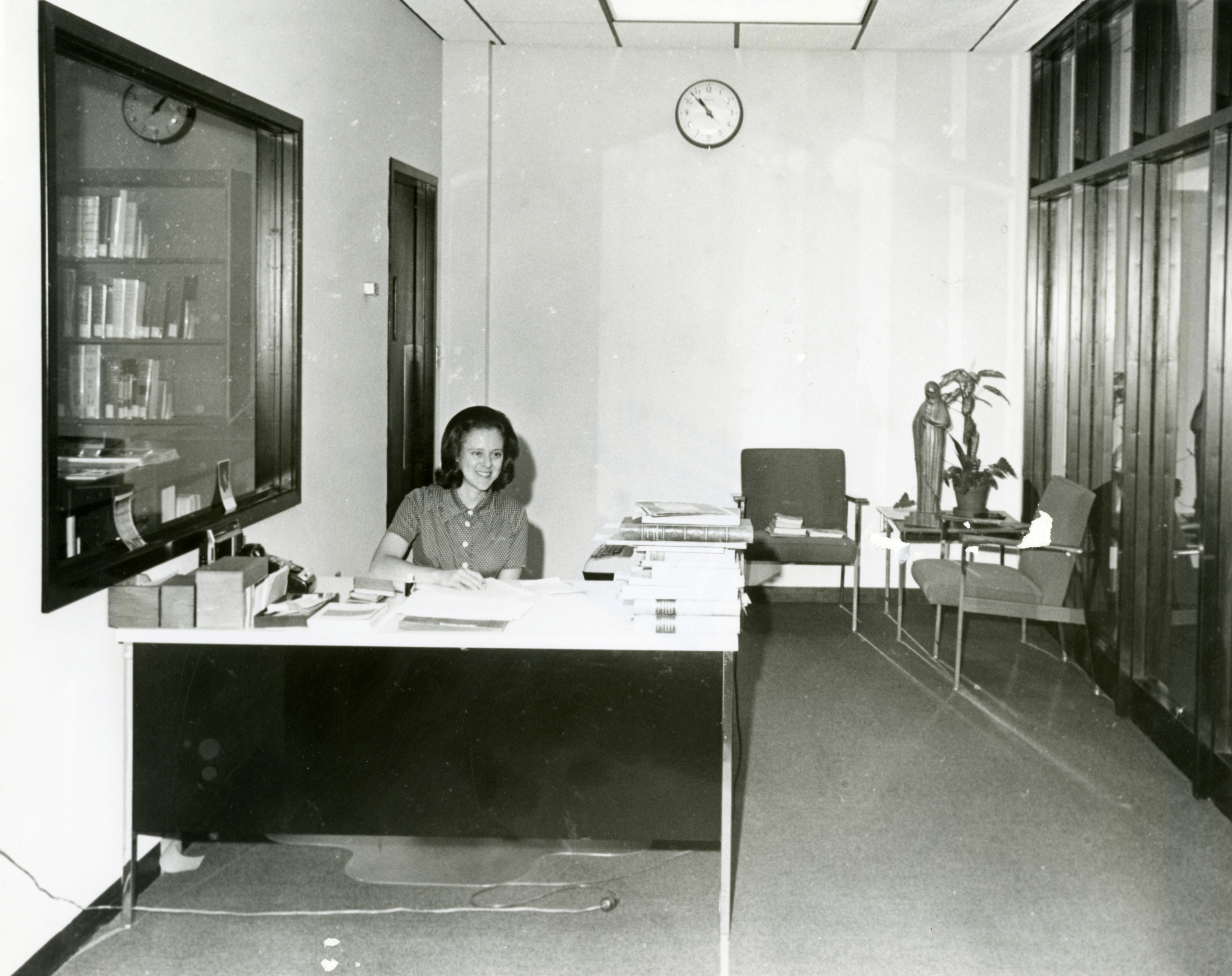 Barbara Gibbons working at the front desk of the Marian Library, circa 1970, after it had moved to the 7th floor of the newly constructed Roesch Library. 