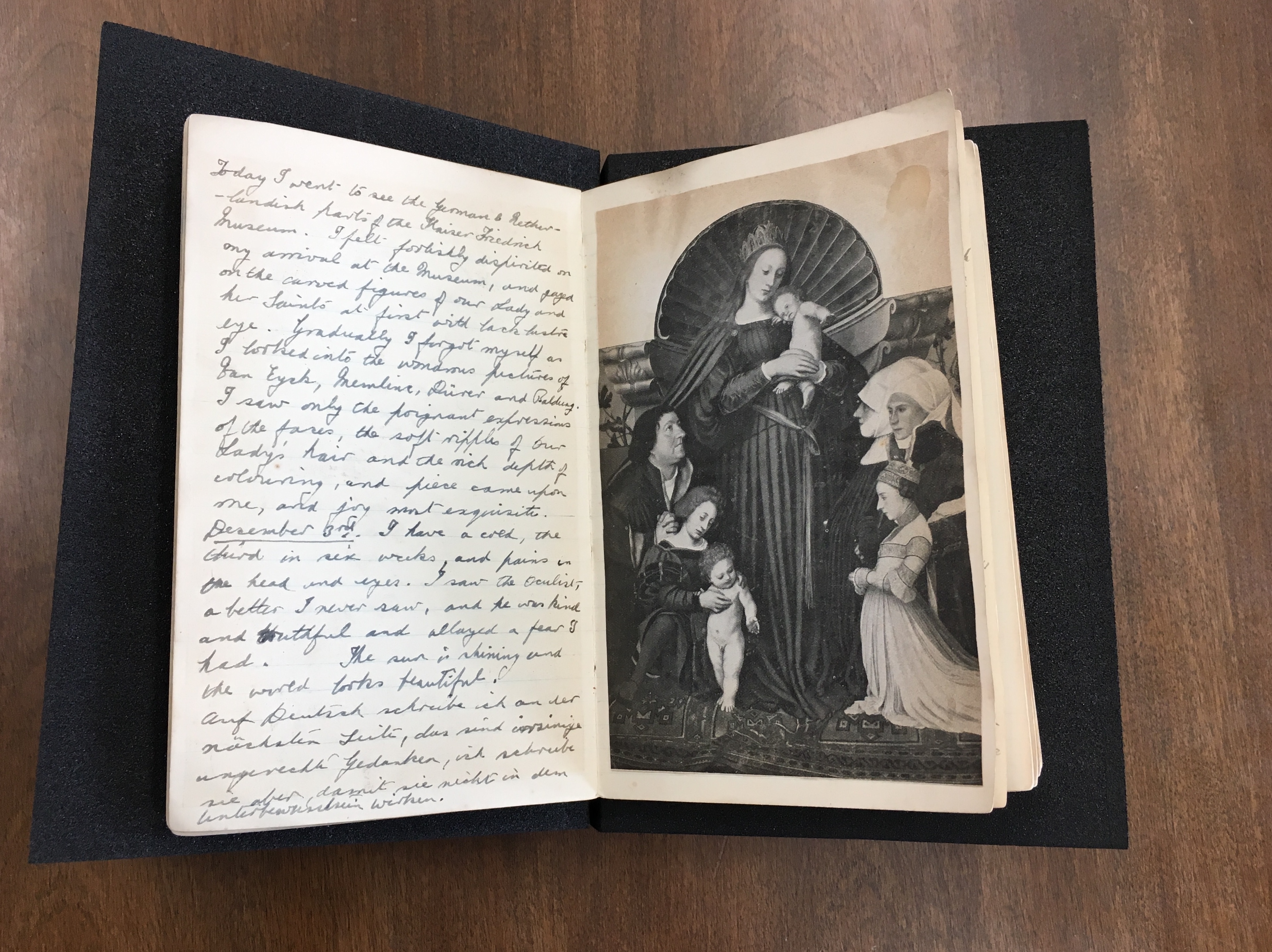 Open diary spread with hand-written entry on the left page and black and white photograph of Marian art on the right