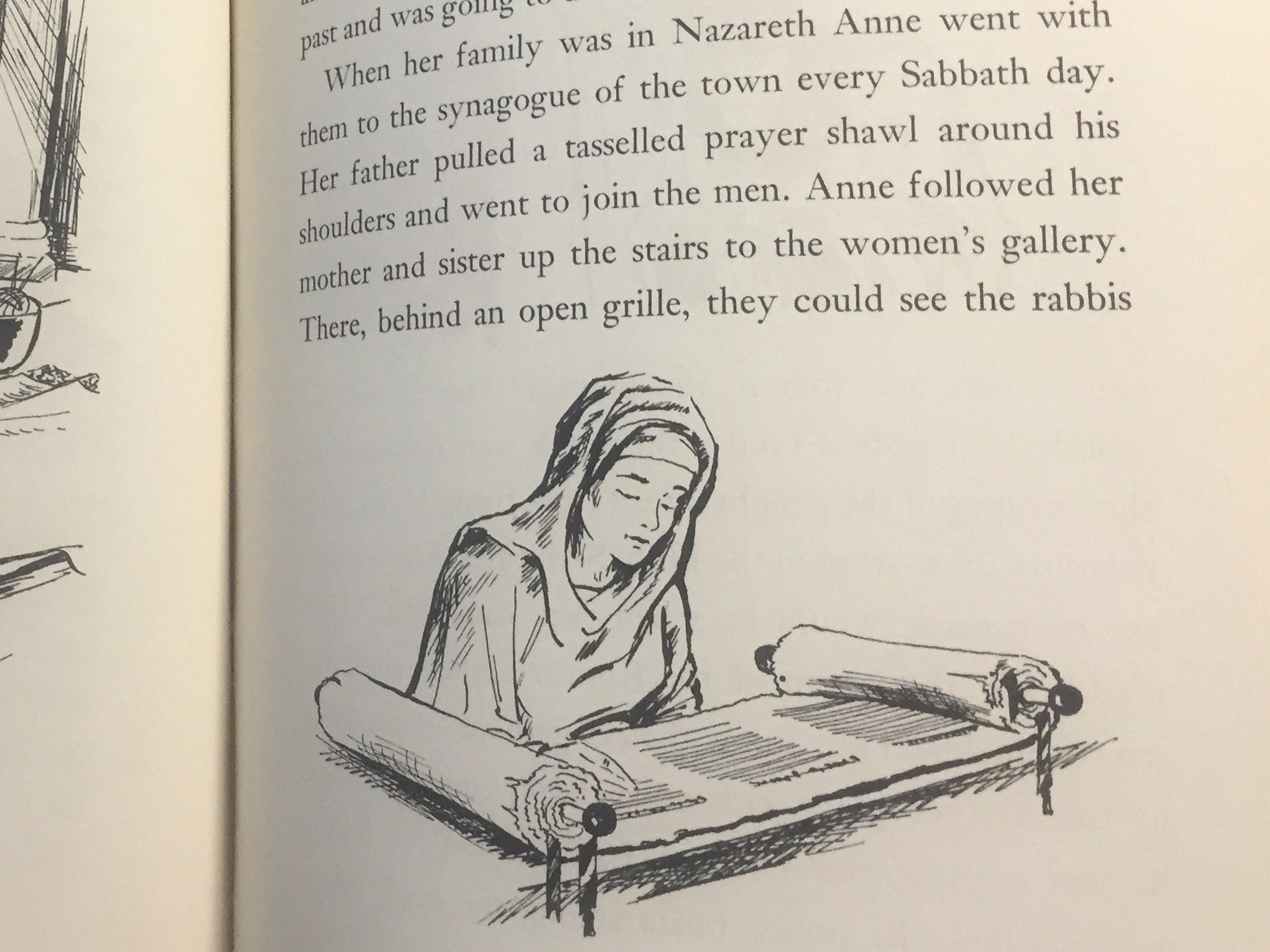 Line drawing of St. Anne as a young woman reading an open scroll