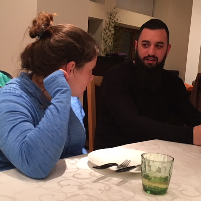 A student talks with a Franciscan Friar during supper.
