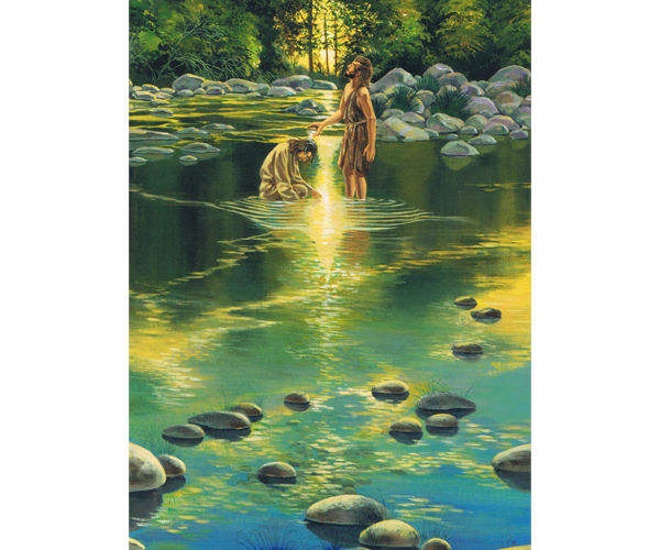 Illustrated water, such as a river, with blue and green tones. Still and reflective water with large, smooth brown rocks scattered in the foreground showing that the water is shallow. Deep in the background, amidst the glow of the sun on the dark green water, a depiction of Jesus in a natural-colored tunic, is in the water with his head bowing while John the Baptist, in dark brown animal skins, stands next to him pouring water from his hand onto Jesus' head. Behind the figures are many large gray rocks and further back are trees with dark brown trunks and dark green foliage. A bit of the yellow sky and sun peeks through the foliage.