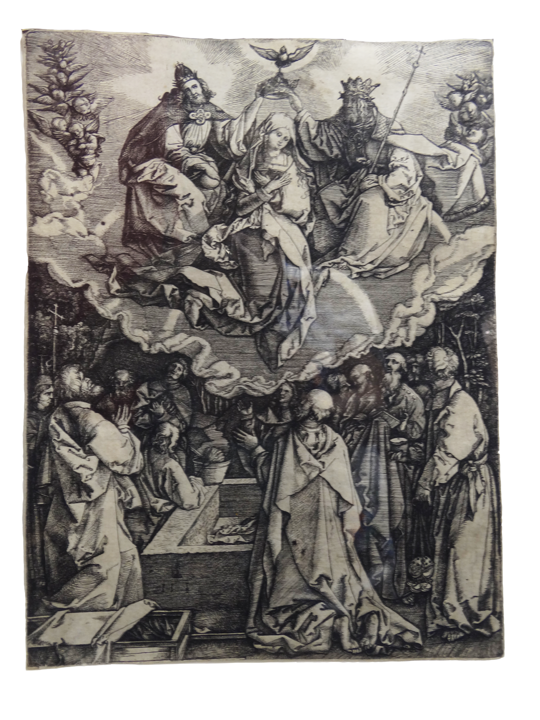 Black and white print. The Blessed Virgin Mary, sitting, is centered on the top half of the image as if rising. Her head is bowed, and her arms are crossed at her chest. A dove representing the Holy Spirit is above her head with a depiction of God the Father on the right and Jesus on the left, each holding the crown above Mary’s head. A grouping of angels is on each side. Below are several onlookers assembled around a burial vault, looking upward.