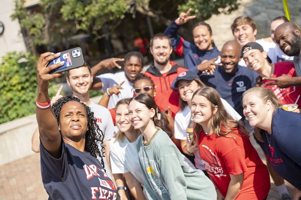 group of students on campus taking a selfie