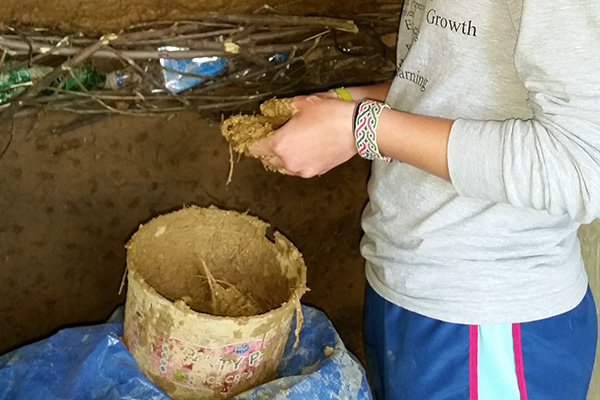 Natural materials used to build and repair walls -- mud and straw, dirt and tires.