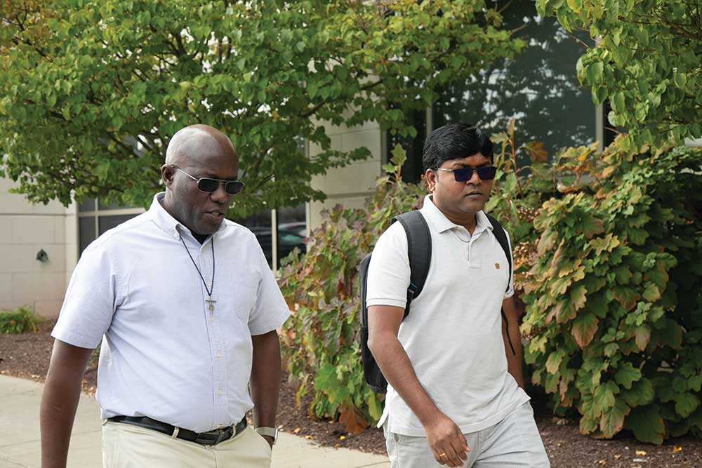 Two brothers walk together on campus.