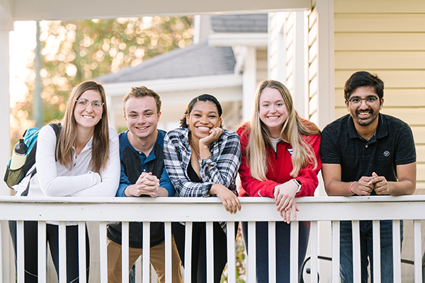 students on porch in neighborhood