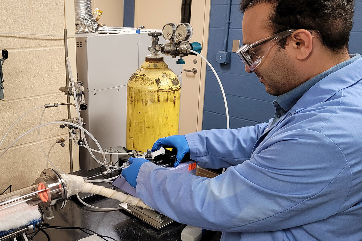Environmental research engineer Forood Karimzadeh prepares a PFAS sample for incineration testing.